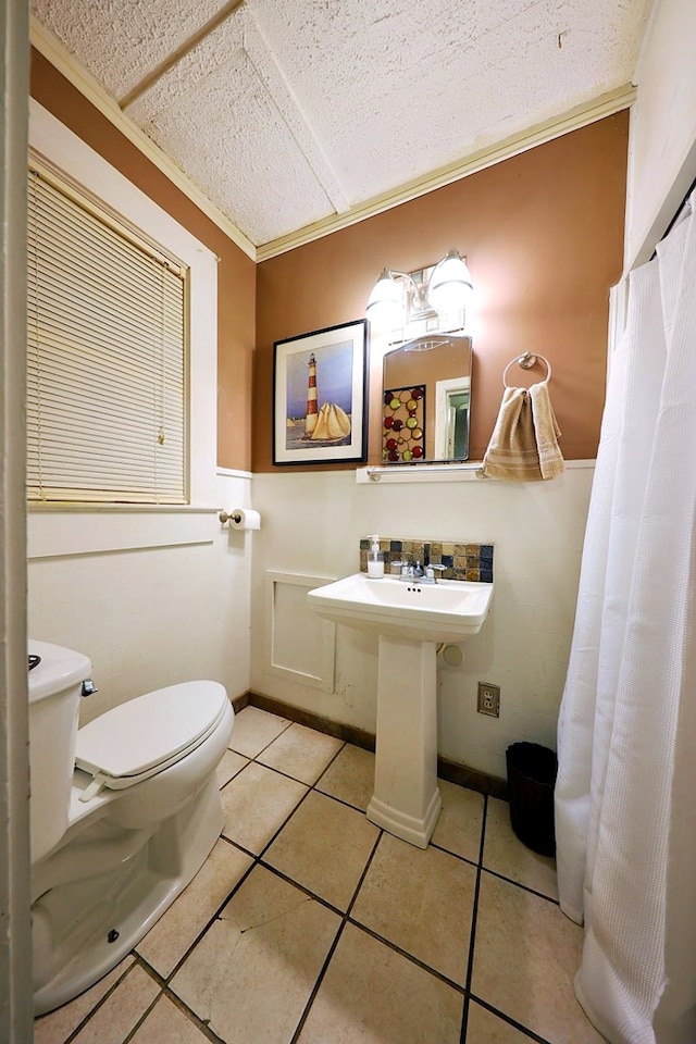 bathroom with toilet and tile patterned floors