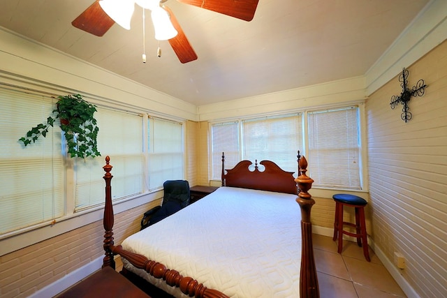 tiled bedroom featuring a ceiling fan and baseboards