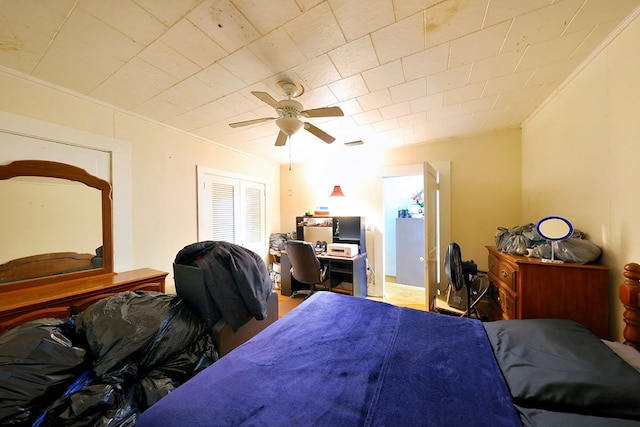 bedroom featuring a ceiling fan and ornamental molding