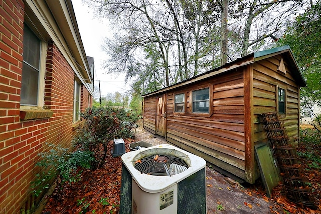 view of home's exterior with brick siding and central AC unit