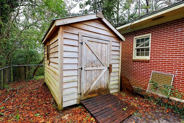 view of shed featuring fence