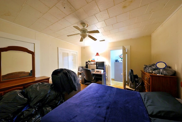 bedroom featuring ceiling fan, ornamental molding, and visible vents