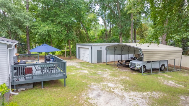 1216 Oriole Dr, Thomasville, GA 31792 - view of grassy yard featuring a wooden deck, driveway, a detached carport, a garage, and view of scattered trees