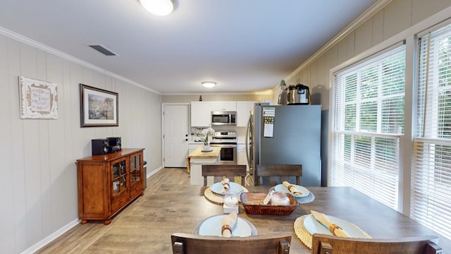 1216 Oriole Dr, Thomasville, GA 31792 - dining space featuring light wood finished floors, plenty of natural light, and ornamental molding