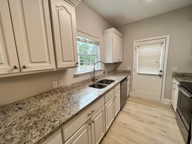 kitchen featuring dishwasher, electric stove, a sink, light wood-style floors, and light stone countertops
