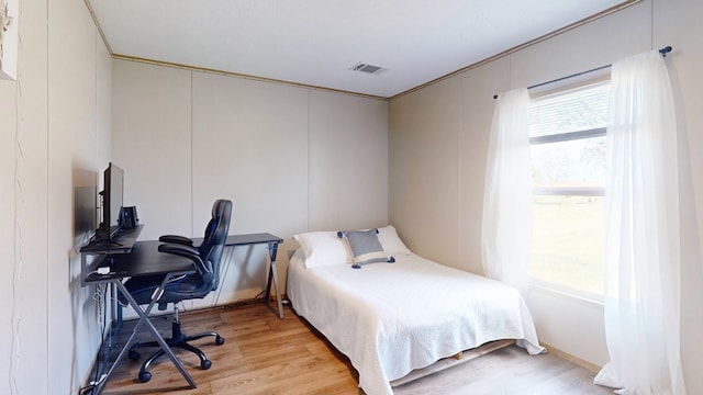 bedroom featuring light wood-type flooring and visible vents