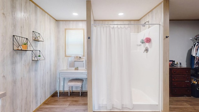 bathroom with ornamental molding, curtained shower, and wood finished floors