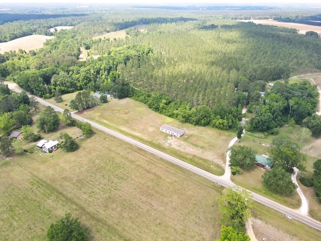 aerial view featuring a view of trees and a rural view