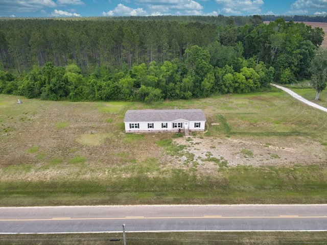 birds eye view of property featuring a wooded view