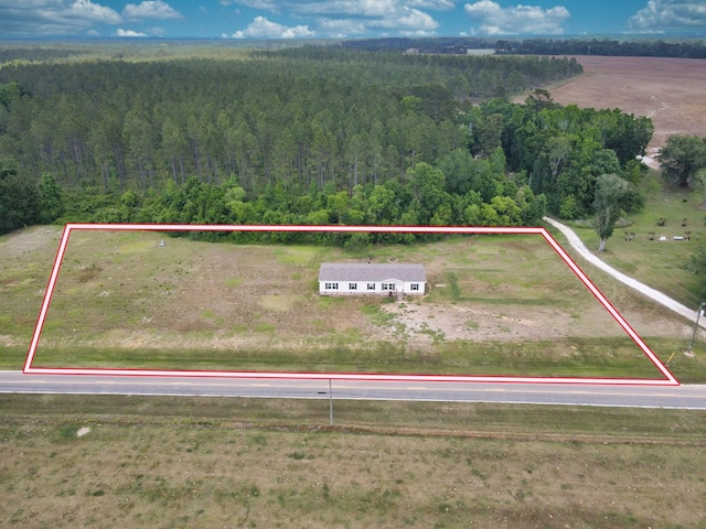 birds eye view of property with a forest view