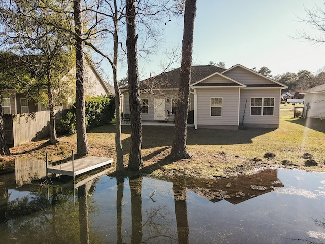 rear view of property featuring a lawn