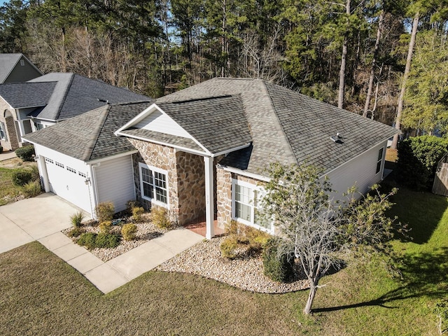 single story home with a front yard and a garage