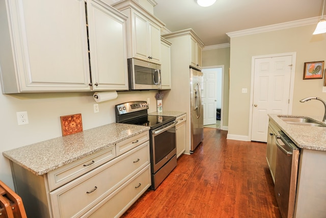 kitchen featuring sink, light stone counters, stainless steel appliances, dark hardwood / wood-style flooring, and ornamental molding