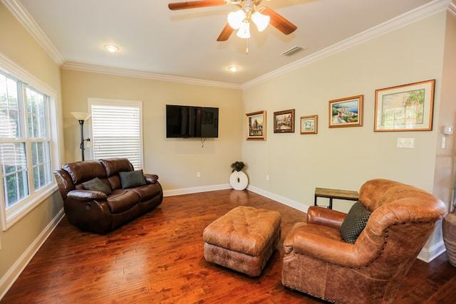 living room with dark hardwood / wood-style flooring, ceiling fan, and crown molding