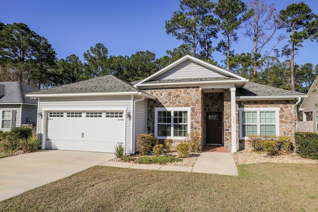 view of front of property with a garage and a front lawn