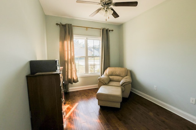 living area featuring ceiling fan and dark hardwood / wood-style flooring