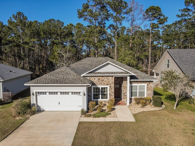 view of front of house with a front lawn and a garage