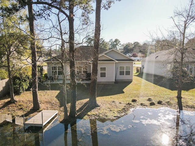 back of property with a patio area and a lawn