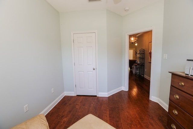 bedroom with dark wood-type flooring