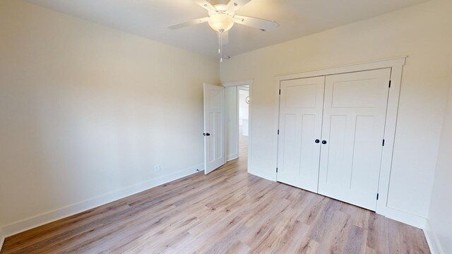 unfurnished bedroom with ceiling fan, light hardwood / wood-style floors, and a closet