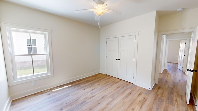 unfurnished bedroom with a closet, ceiling fan, and light hardwood / wood-style flooring