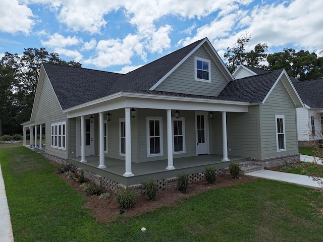 view of side of home with a yard and covered porch