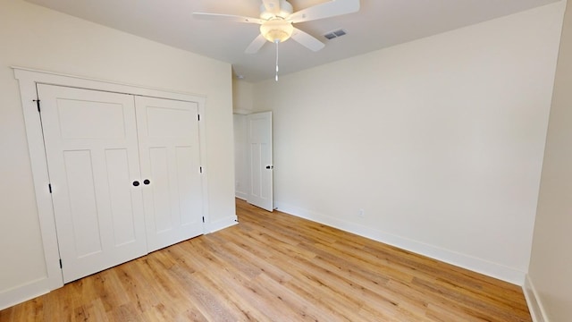 unfurnished bedroom featuring light hardwood / wood-style floors, a closet, and ceiling fan