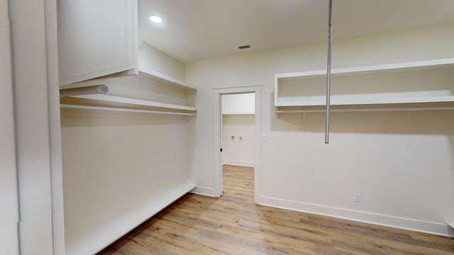 walk in closet featuring light hardwood / wood-style floors