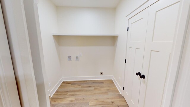 laundry room with hookup for a washing machine, light hardwood / wood-style flooring, and electric dryer hookup