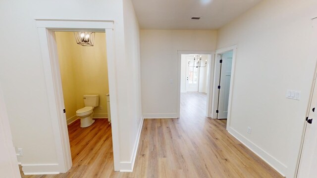 hall with light hardwood / wood-style floors