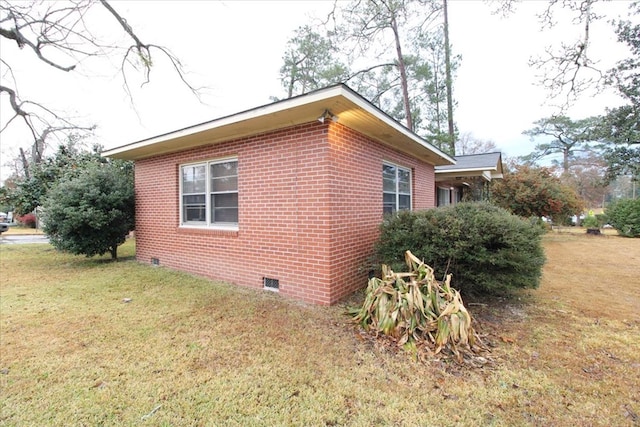 303 SE 4th Ave, Cairo, GA 39828 - view of property exterior with crawl space, a lawn, and brick siding