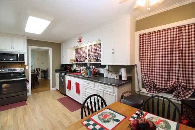 kitchen featuring white cabinetry, crown molding, light hardwood / wood-style flooring, and appliances with stainless steel finishes