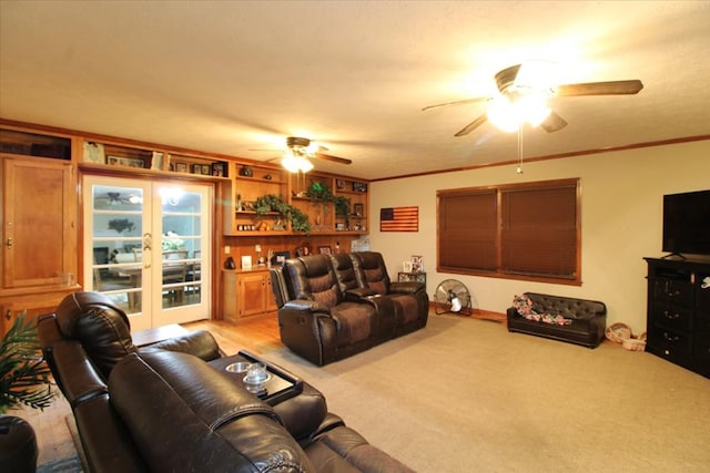 carpeted living room with ornamental molding, french doors, and ceiling fan