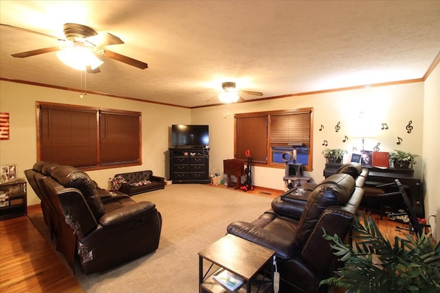 carpeted living room with ornamental molding, a textured ceiling, and ceiling fan