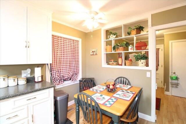 dining space with crown molding, light hardwood / wood-style flooring, and ceiling fan