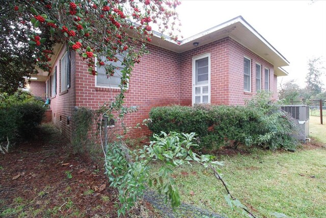 view of property exterior featuring a yard and central AC unit