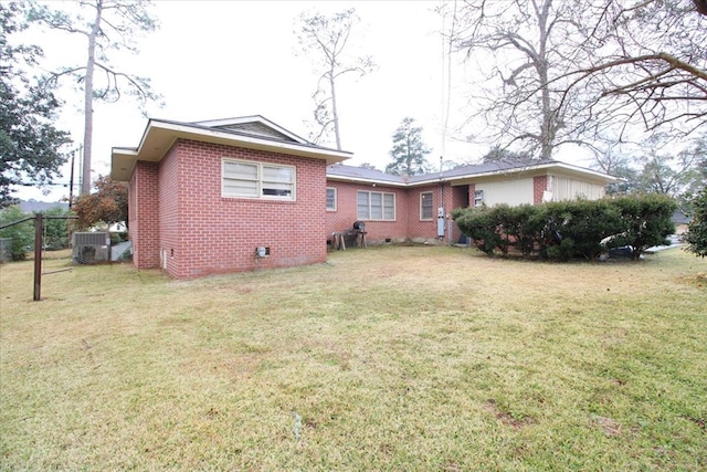 303 SE 4th Ave, Cairo, GA 39828 - back of house with brick siding, crawl space, a lawn, and central AC