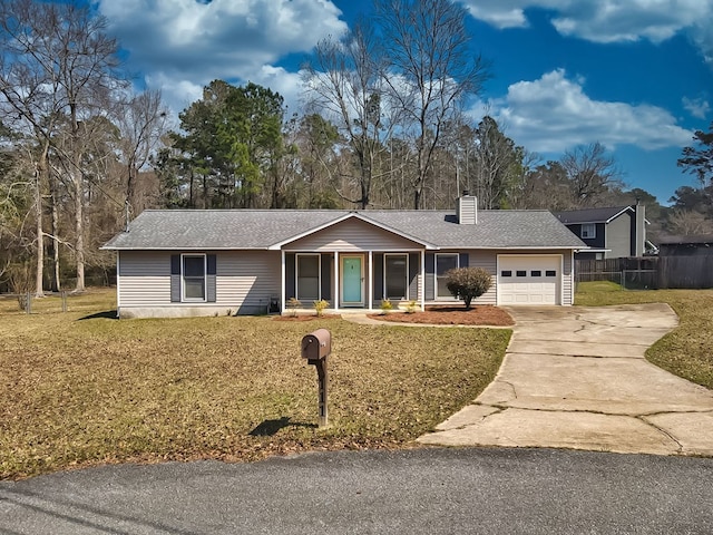 ranch-style home featuring concrete driveway, an attached garage, a front yard, and a chimney