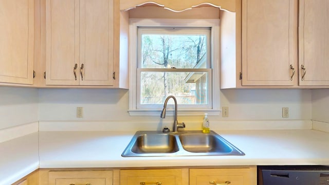 kitchen featuring a sink, dishwasher, light brown cabinets, and light countertops