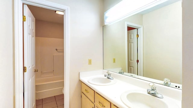 full bath featuring tile patterned floors, toilet, double vanity, and a sink