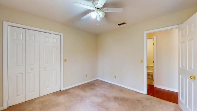 unfurnished bedroom featuring visible vents, ceiling fan, baseboards, carpet floors, and a closet