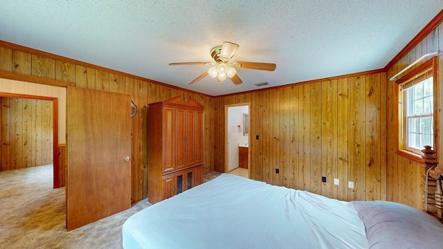 2001 Redfearn St, Barwick, GA 31720 - bedroom featuring light carpet, wood walls, ornamental molding, a textured ceiling, and a ceiling fan