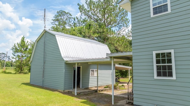 2001 Redfearn St, Barwick, GA 31720 - view of side of property with a gambrel roof, a lawn, and a metal roof