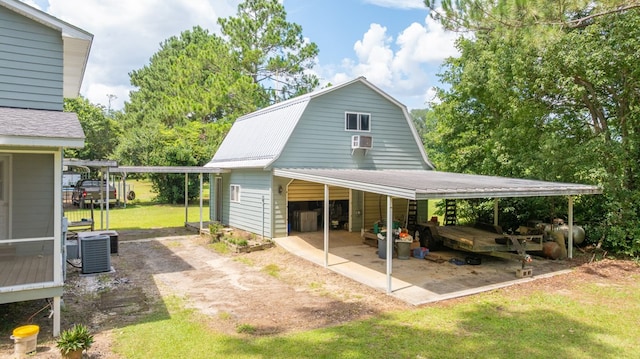 2001 Redfearn St, Barwick, GA 31720 - rear view of property with a garage, a yard, a gambrel roof, cooling unit, and a metal roof