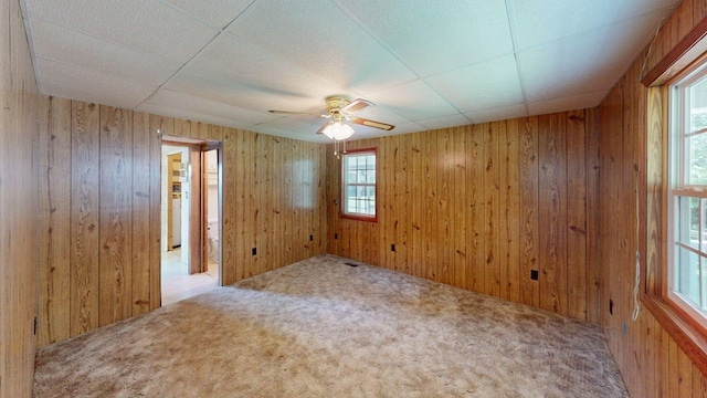 2001 Redfearn St, Barwick, GA 31720 - spare room featuring a ceiling fan, wooden walls, and carpet flooring