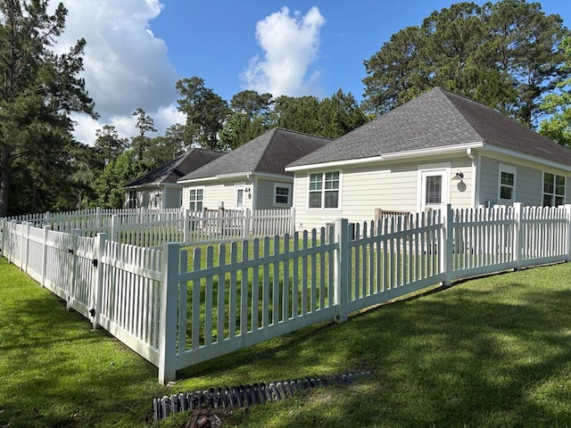 rear view of house with roof with shingles