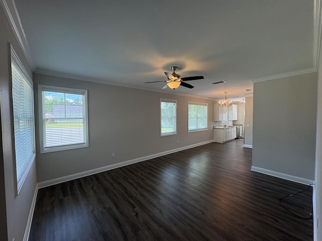 empty room featuring crown molding, a chandelier, baseboards, dark wood-style flooring, and ceiling fan
