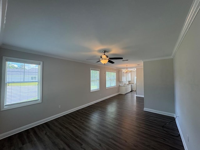 unfurnished living room featuring a chandelier, dark wood-style floors, crown molding, baseboards, and ceiling fan