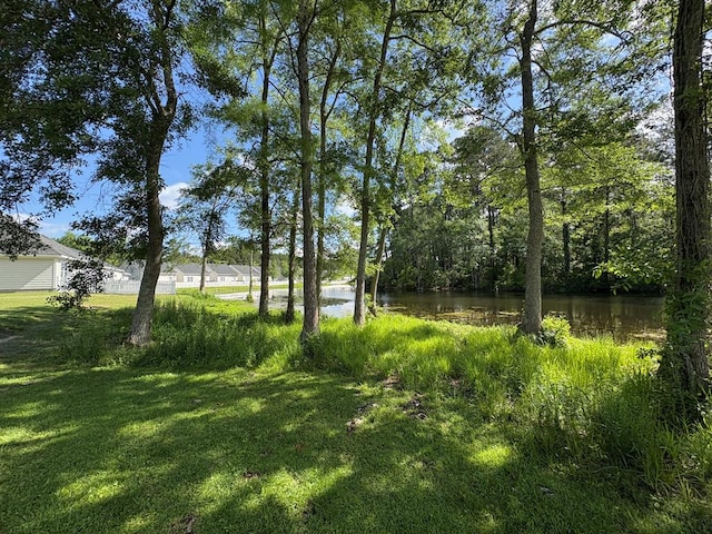 view of grassy yard with a water view