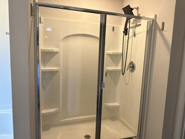 bathroom featuring a shower with door